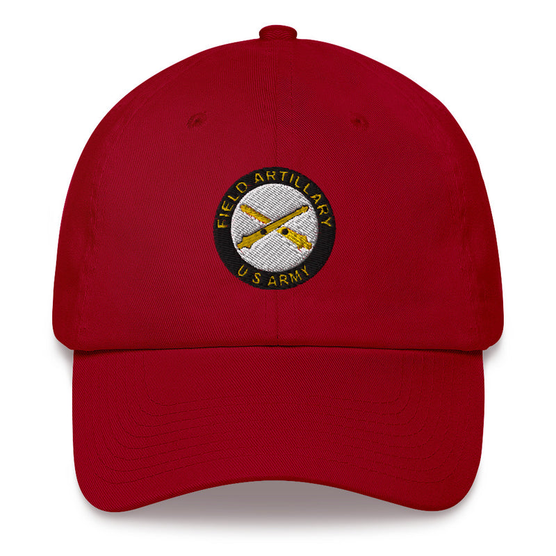 A cranberry colored US Army Field Artillery Hat with the logo on the front.  The hat has a curved visor and an adjustable strap at the back.