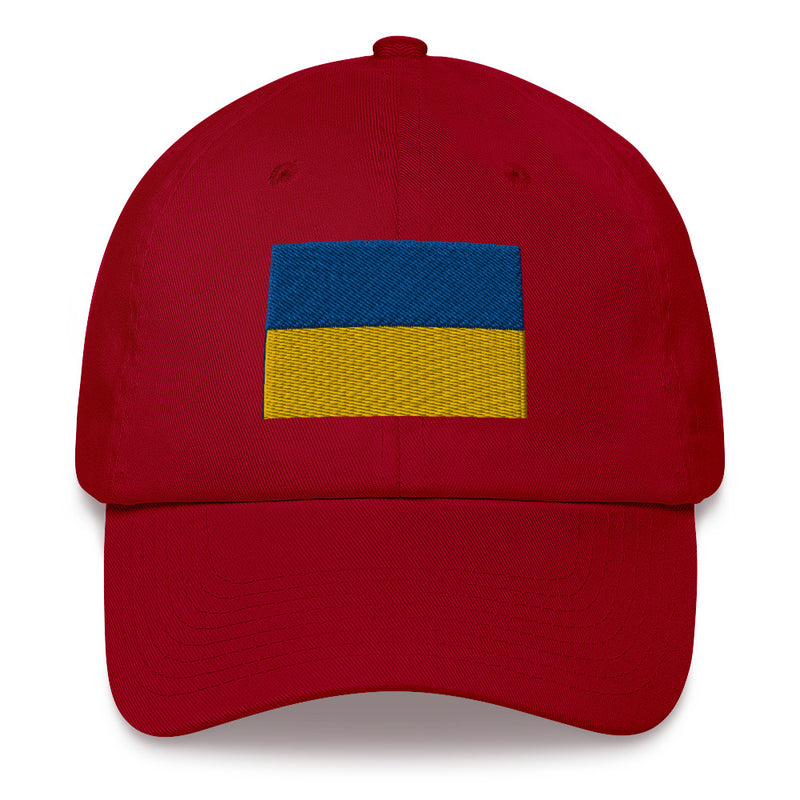 A cranberry colored Ukrainian Flag Hat with the logo on the front.  The hat has a curved visor and an adjustable strap at the back.