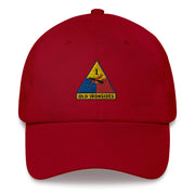 A cranberry colored 1st Armored Division Hat with the logo on the front.  The hat has a curved visor and an adjustable strap at the back.