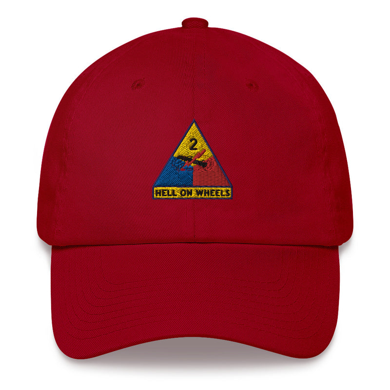 A cranberry colored 2nd Armored Division Hat with the logo on the front.  The hat has a curved visor and an adjustable strap at the back.