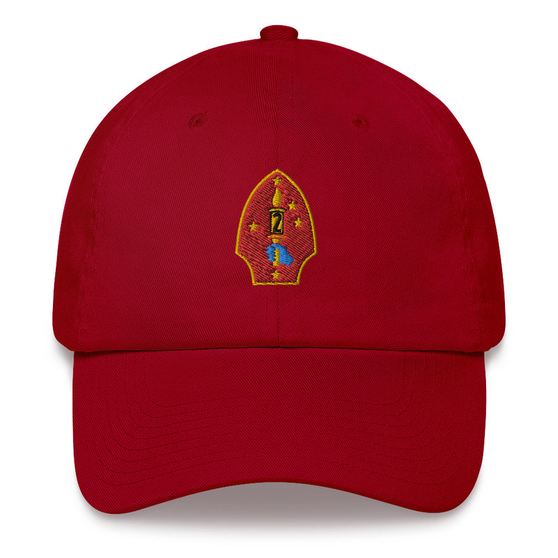 A cranberry colored 2nd Marine Division Hat with the logo on the front.  The hat has a curved visor and an adjustable strap at the back.