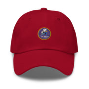 A cranberry colored Navy Seabees Hat with the logo on the front.  The hat has a curved visor and an adjustable strap at the back.