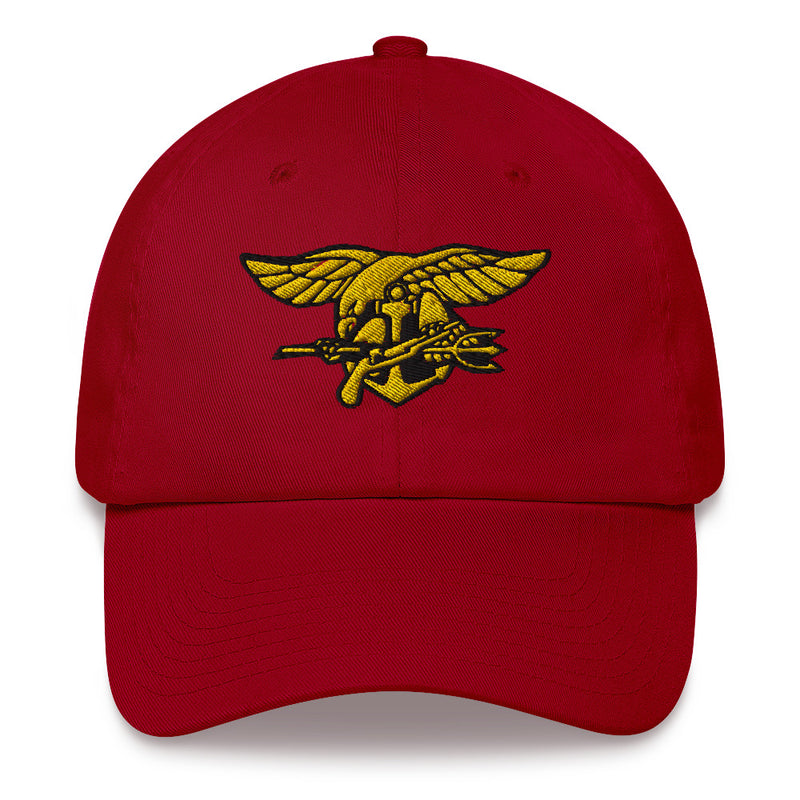 A cranberry colored Navy Seals Hat with the logo on the front.  The hat has a curved visor and an adjustable strap at the back.