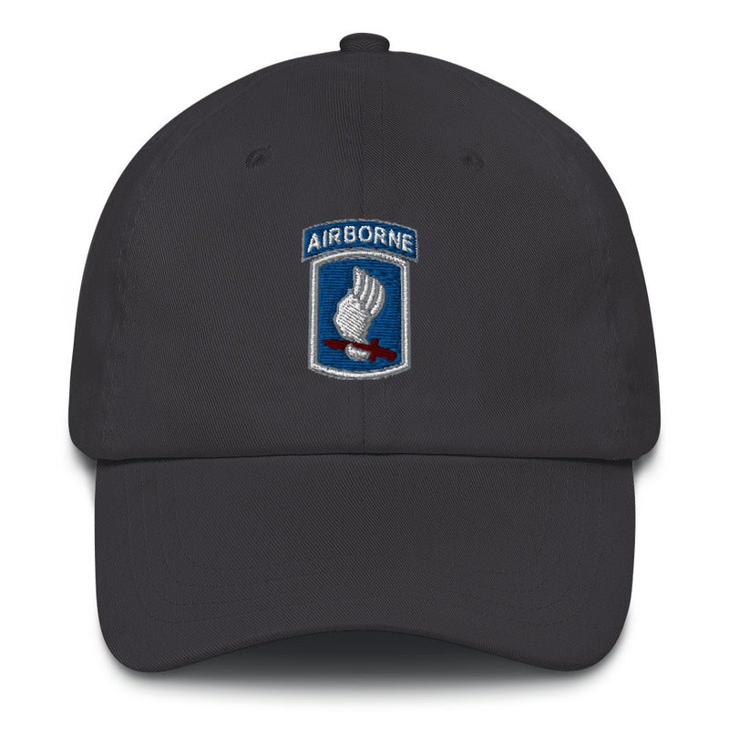 A dark grey 173rd Airborne Brigade Hat with the logo on the front.  The hat has a curved visor and an adjustable strap at the back.