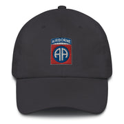 A dark grey 82nd Airborne Hat with the logo on the front.  The hat has a curved visor and an adjustable strap at the back.