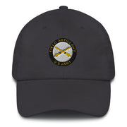 A dark grey US Army Field Artillery Hat with the logo on the front.  The hat has a curved visor and an adjustable strap at the back.