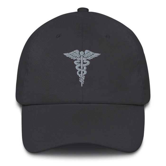 A dark grey Hospital Corpsman Hat with the logo on the front.  The hat has a curved visor and an adjustable strap at the back.