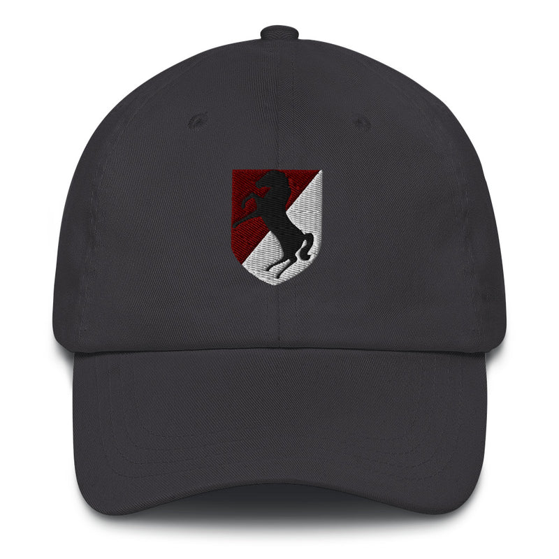 A dark grey 11th Armored Cavalry Regiment Hat with the logo on the front.  The hat has a curved visor and an adjustable strap at the back.