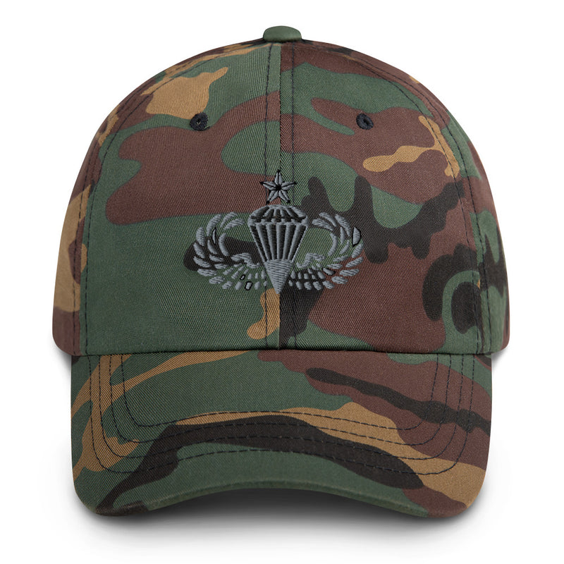 A military style Senior Parachutist Division Hat with camouflage and the logo on the front.  The hat has a curved visor and an adjustable strap at the back. 