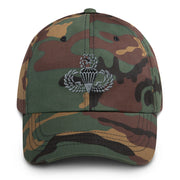 A military style Master Parachutist Hat with camouflage and the logo on the front.  The hat has a curved visor and an adjustable strap at the back. 