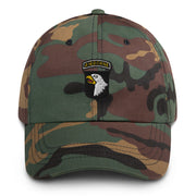 A military style 101st Airborne Hat with camouflage and the logo on the front.  The hat has a curved visor and an adjustable strap at the back. 