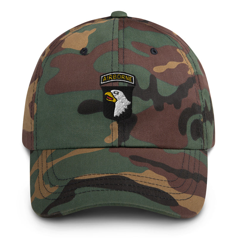 A military style 101st Airborne Hat with camouflage and the logo on the front.  The hat has a curved visor and an adjustable strap at the back. 