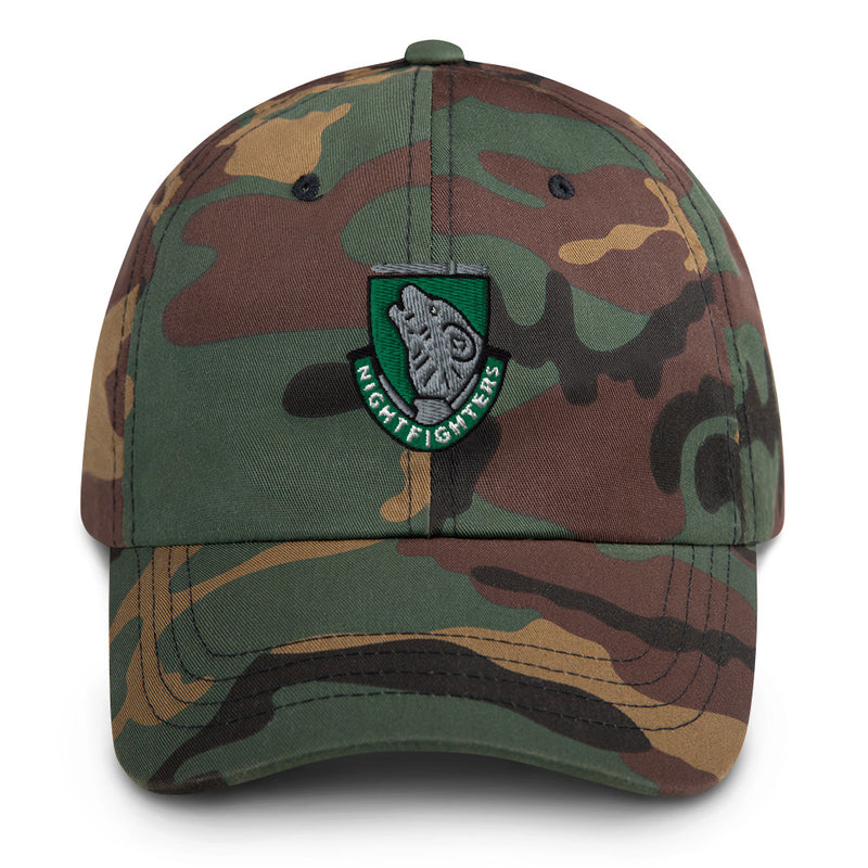 A military style 104th Infantry Division Hat with camouflage and the logo on the front.  The hat has a curved visor and an adjustable strap at the back. 