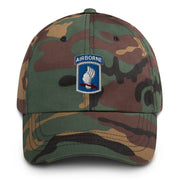A military style 173rd Airborne Brigade Hat with camouflage and the logo on the front.  The hat has a curved visor and an adjustable strap at the back. 