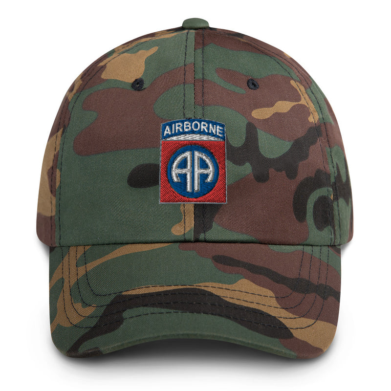 A military style 82nd Airborne Hat with camouflage and the logo on the front.  The hat has a curved visor and an adjustable strap at the back. 