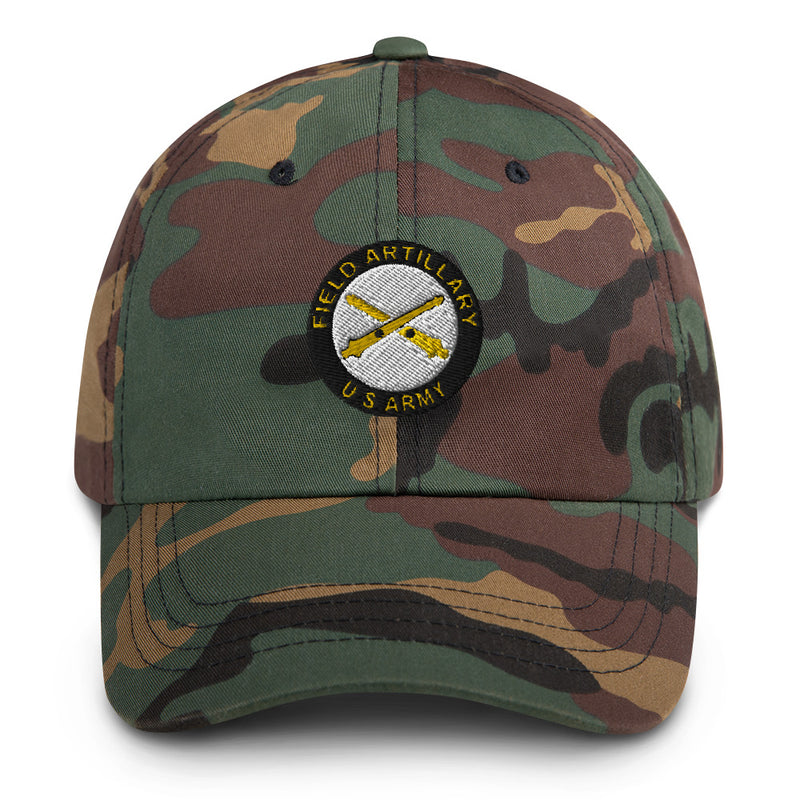 A military style US Army Field Artillery Hat with camouflage and the logo on the front.  The hat has a curved visor and an adjustable strap at the back. 