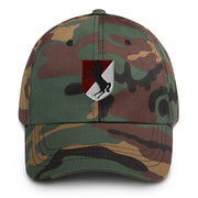 A military style 11th Armored Cavalry Regiment Hat with camouflage and the logo on the front.  The hat has a curved visor and an adjustable strap at the back. 