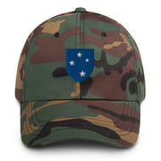 A military style 23rd Infantry Division Hat with camouflage and the logo on the front.  The hat has a curved visor and an adjustable strap at the back. 