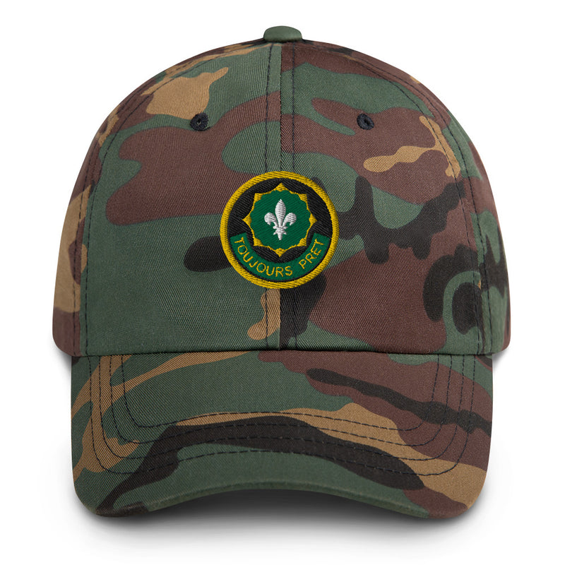 A military style 2nd-cavalry-regiment Hat with camouflage and the logo on the front.  The hat has a curved visor and an adjustable strap at the back. 