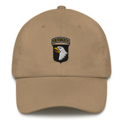 A khaki colored 101st Airborne Hat with the logo on the front.  The hat has a curved visor and an adjustable strap at the back.