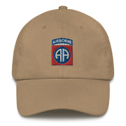 A khaki colored 82nd Airborne Hat with the logo on the front.  The hat has a curved visor and an adjustable strap at the back.