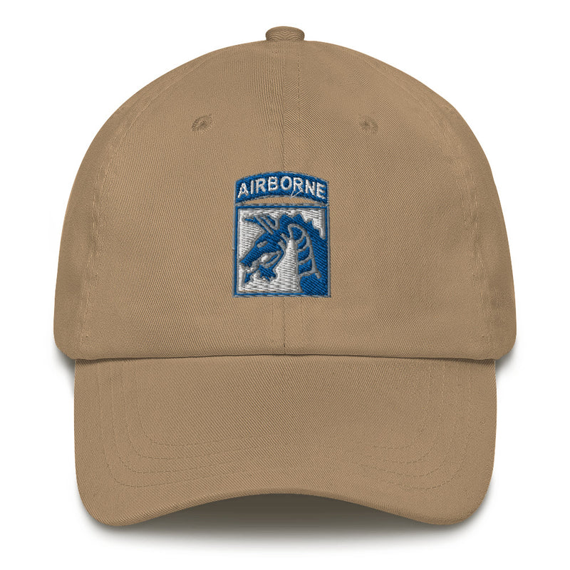 A khaki colored XVIII Airborne Corps Hat with the logo on the front.  The hat has a curved visor and an adjustable strap at the back.