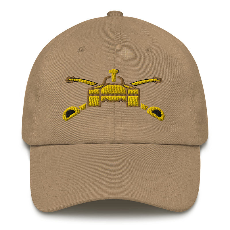 A khaki colored Army Armor Hat with the logo on the front.  The hat has a curved visor and an adjustable strap at the back.
