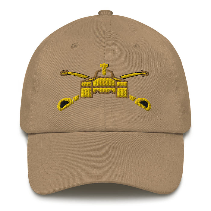 A khaki colored Army Armor Hat with the logo on the front.  The hat has a curved visor and an adjustable strap at the back.