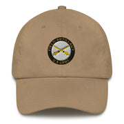 A khaki colored US Army Field Artillery Hat with the logo on the front.  The hat has a curved visor and an adjustable strap at the back.