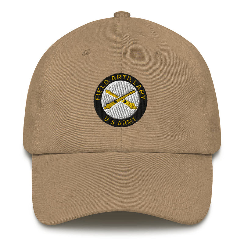 A khaki colored US Army Field Artillery Hat with the logo on the front.  The hat has a curved visor and an adjustable strap at the back.
