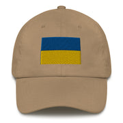 A khaki colored Ukrainian Flag Hat with the logo on the front.  The hat has a curved visor and an adjustable strap at the back.