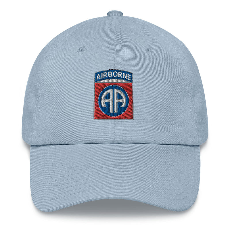 A light blue 82nd Airborne Hat with the logo on the front.  The hat has a curved visor and an adjustable strap at the back.