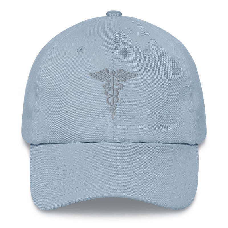 A light blue Hospital Corpsman Hat with the logo on the front.  The hat has a curved visor and an adjustable strap at the back.