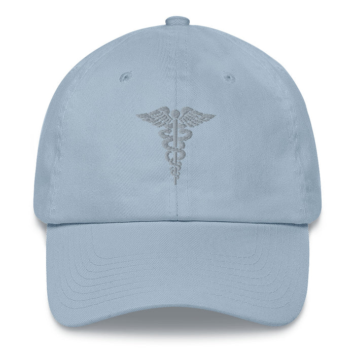 A light blue Hospital Corpsman Hat with the logo on the front.  The hat has a curved visor and an adjustable strap at the back.