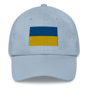 A light blue Ukrainian Flag Hat with the logo on the front.  The hat has a curved visor and an adjustable strap at the back.