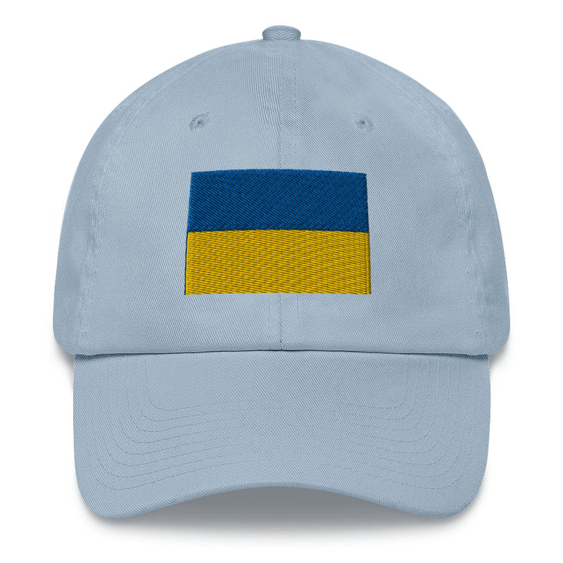 A light blue Ukrainian Flag Hat with the logo on the front.  The hat has a curved visor and an adjustable strap at the back.