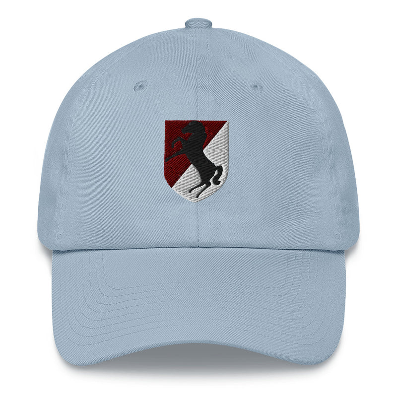 A light blue 11th Armored Cavalry Regiment Hat with the logo on the front.  The hat has a curved visor and an adjustable strap at the back.