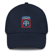 A navy blue 82nd Airborne Hat with the logo on the front.  The hat has a curved visor and an adjustable strap at the back.
