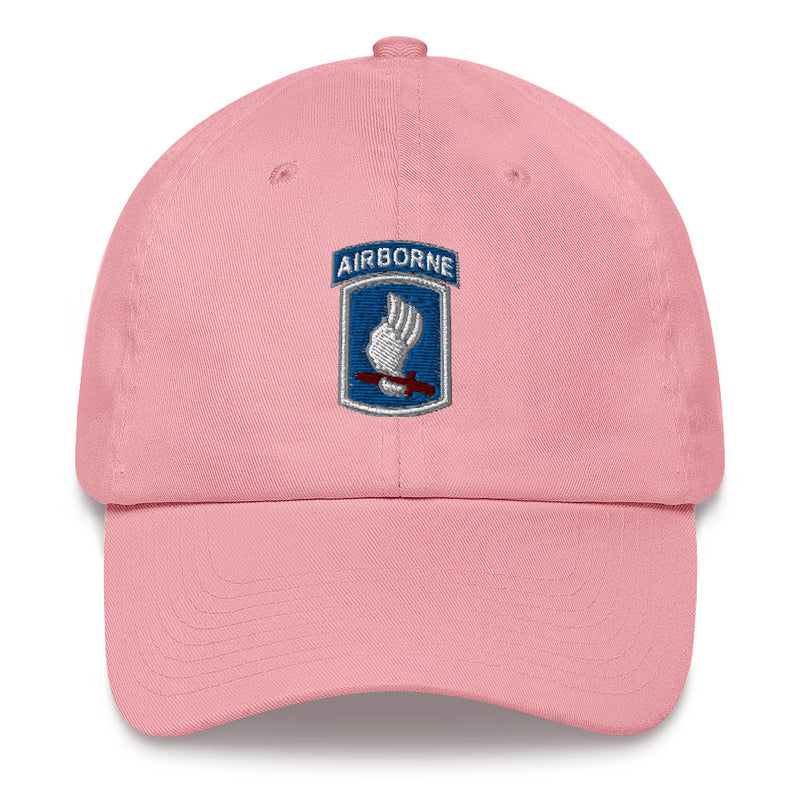 A pink 173rd Airborne Brigade Hat with the logo on the front.  The hat has a curved visor and an adjustable strap at the back.