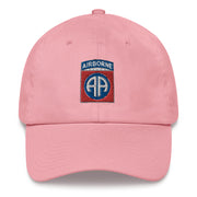 A pink 82nd Airborne Hat with the logo on the front.  The hat has a curved visor and an adjustable strap at the back.