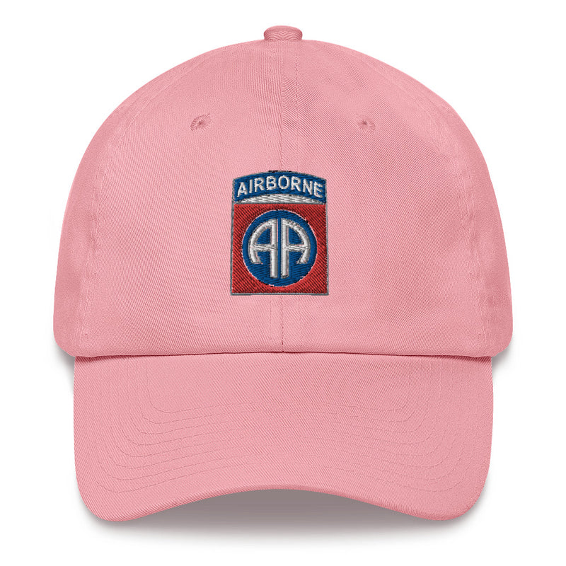 A pink 82nd Airborne Hat with the logo on the front.  The hat has a curved visor and an adjustable strap at the back.