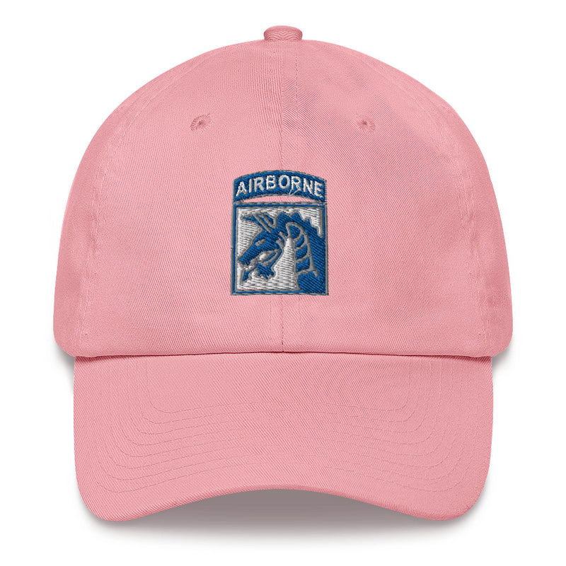 A pink XVIII Airborne Corps Hat with the logo on the front.  The hat has a curved visor and an adjustable strap at the back.
