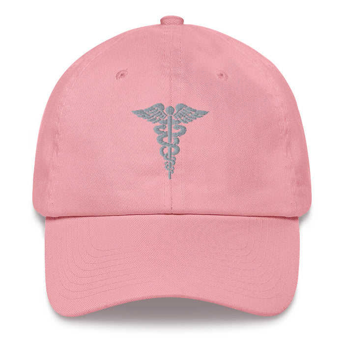 A pink Hospital Corpsman Hat with the logo on the front.  The hat has a curved visor and an adjustable strap at the back.