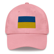 A pink Ukrainian Flag Hat with the logo on the front.  The hat has a curved visor and an adjustable strap at the back.