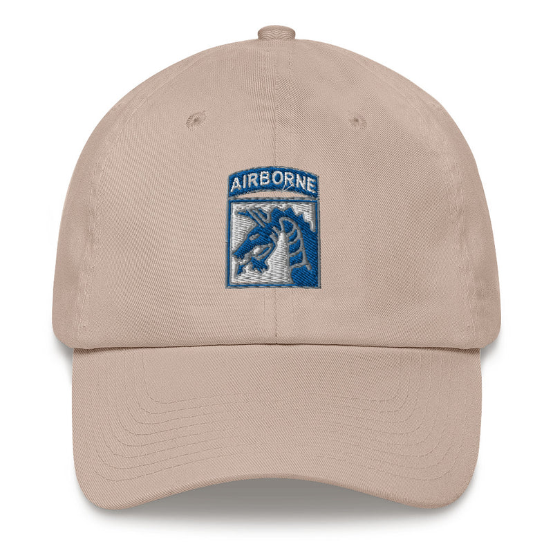 A stone colored XVIII Airborne Corps Hat with the logo on the front.  The hat has a curved visor and an adjustable strap at the back.