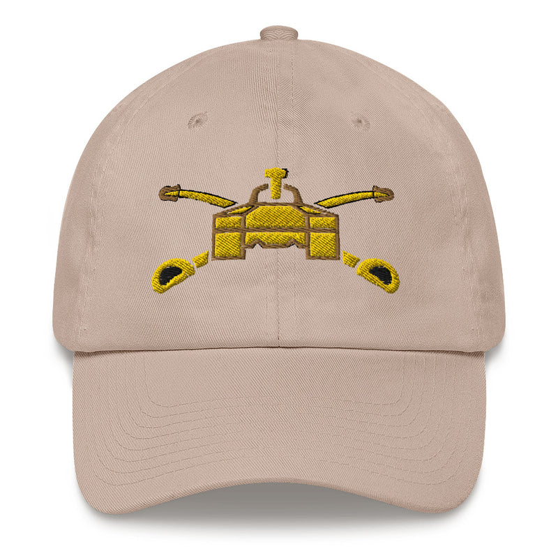 A stone colored Army Armor Hat with the logo on the front.  The hat has a curved visor and an adjustable strap at the back.