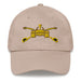 A stone colored Army Armor Hat with the logo on the front.  The hat has a curved visor and an adjustable strap at the back.