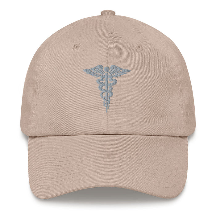 A stone colored Hospital Corpsman Hat with the logo on the front.  The hat has a curved visor and an adjustable strap at the back.