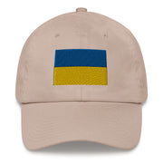 A stone colored Ukrainian Flag Hat with the logo on the front.  The hat has a curved visor and an adjustable strap at the back.