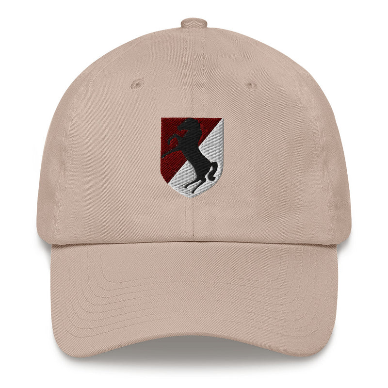 A stone colored 11th Armored Cavalry Regiment Hat with the logo on the front.  The hat has a curved visor and an adjustable strap at the back.